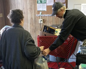 Mark, a volunteer at our Tulakes pantry, helping a client with her cart.
